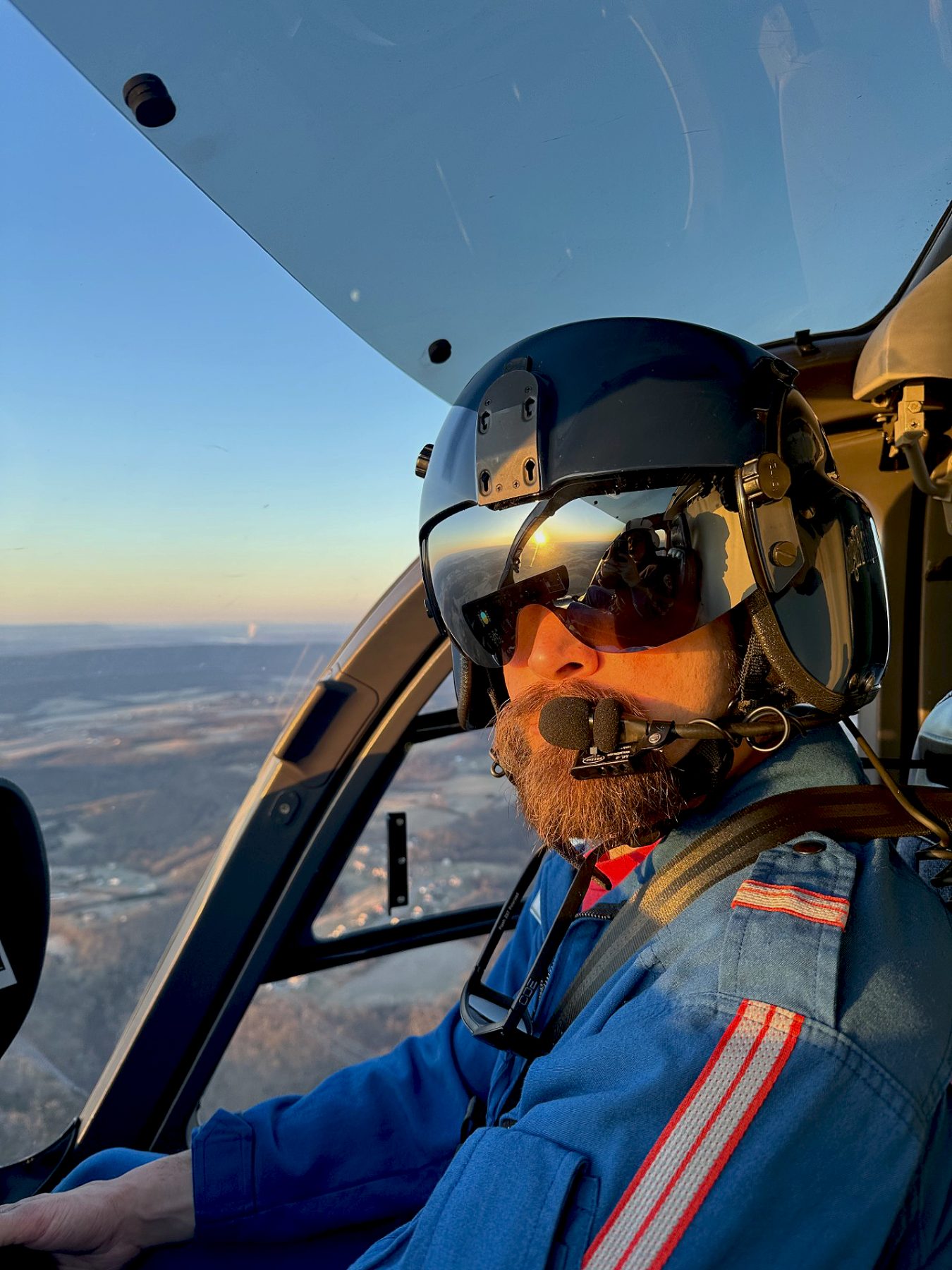Rob at the controls of a Life Flight helicopter at sunset